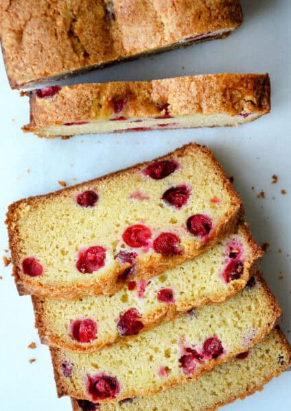 A loaf of cranberry orange bread cut into slices.