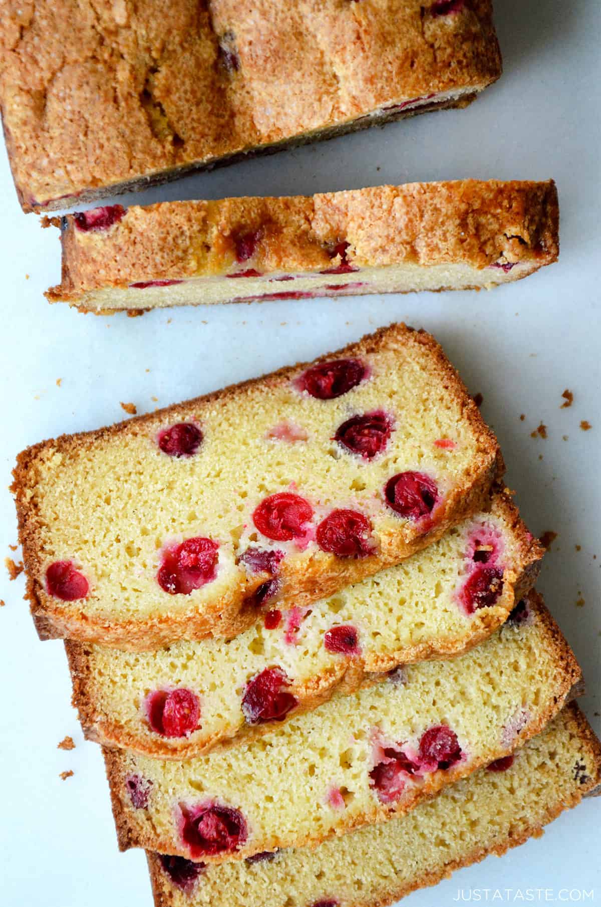 A loaf of cranberry orange bread cut into slices.