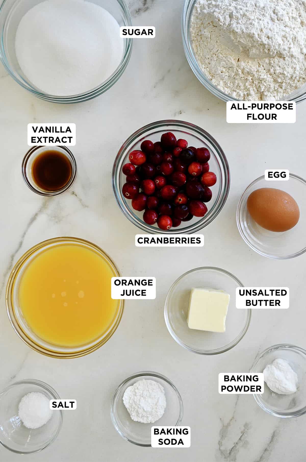 Orange cranberry ingredients in various sizes of glass bowls.