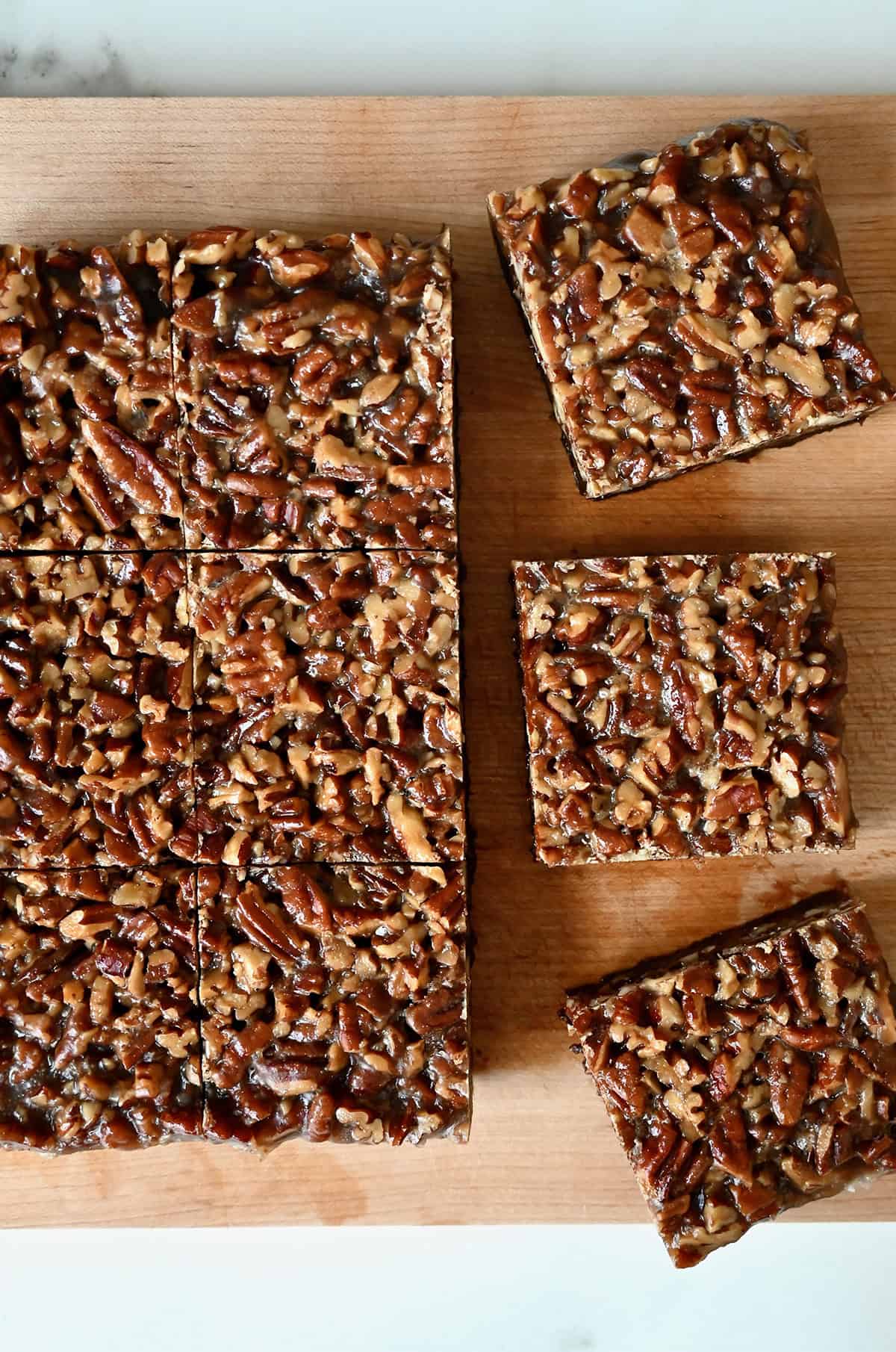 Pecan pie brownie squares on a cutting board.