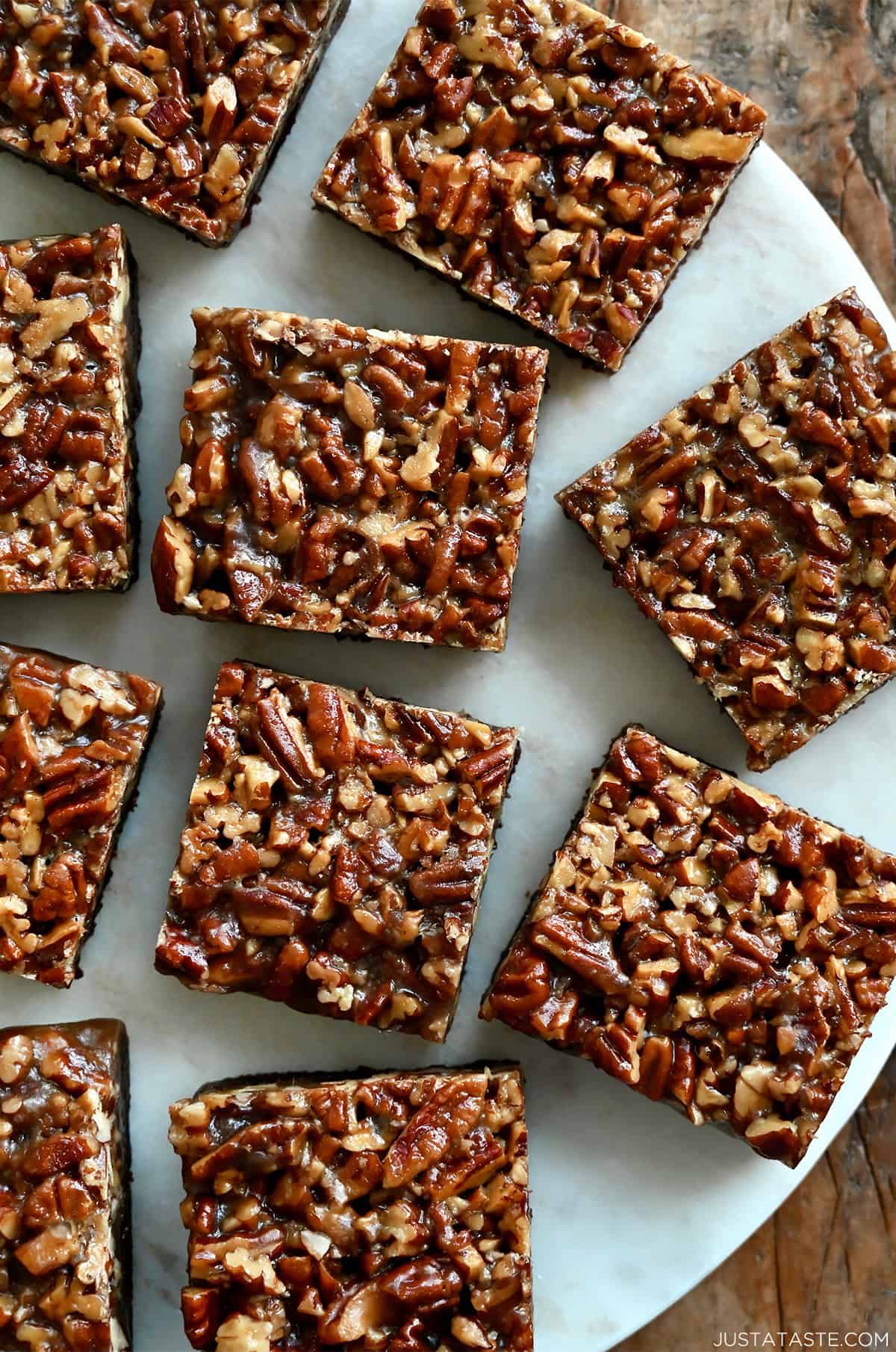 Pecan pie brownie squares on a marble surface.