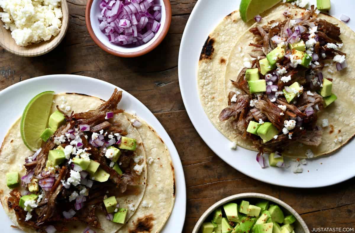 Tender pulled pork piled atop corn tortillas and topped with pickled onions, diced avocado and cojita cheese.