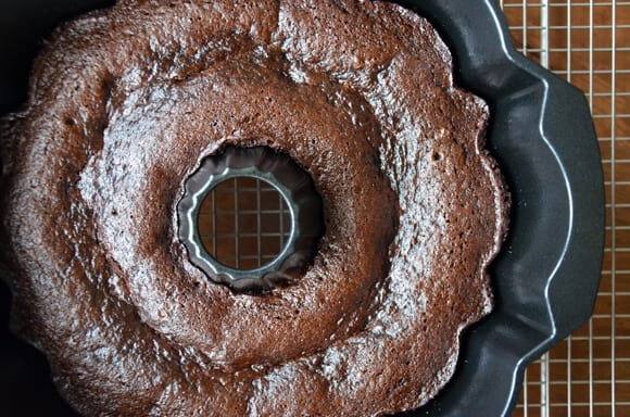 A bundt pan containing freshly baked chocolate gingerbread cake.