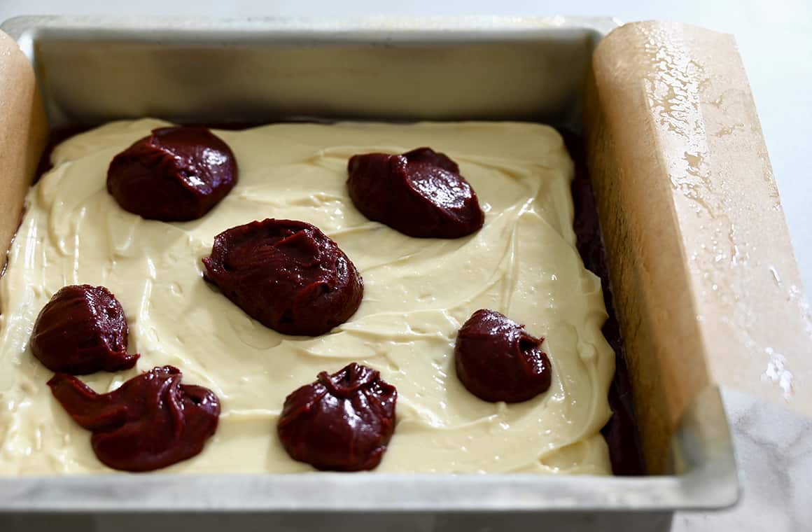 Dollops of batter ready to be swirled into cheesecake layer