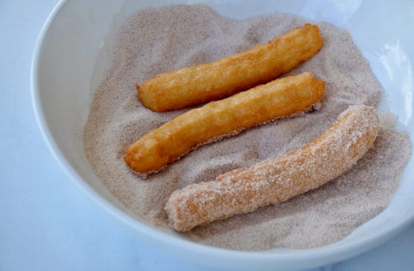 Bowl with cinnamon-sugar mixture to coat freshly deep-fried churros