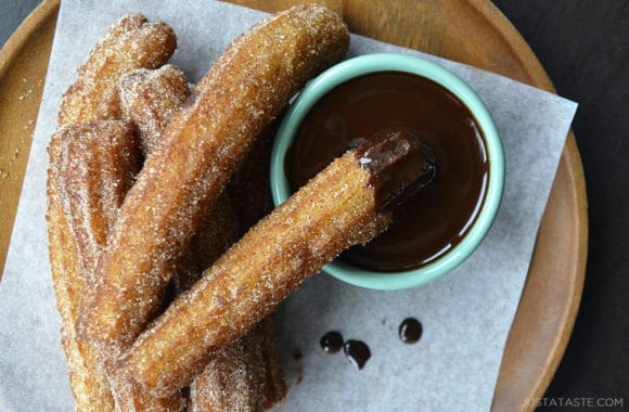 Top down view of easy homemade churros dunked in chocolate sauce