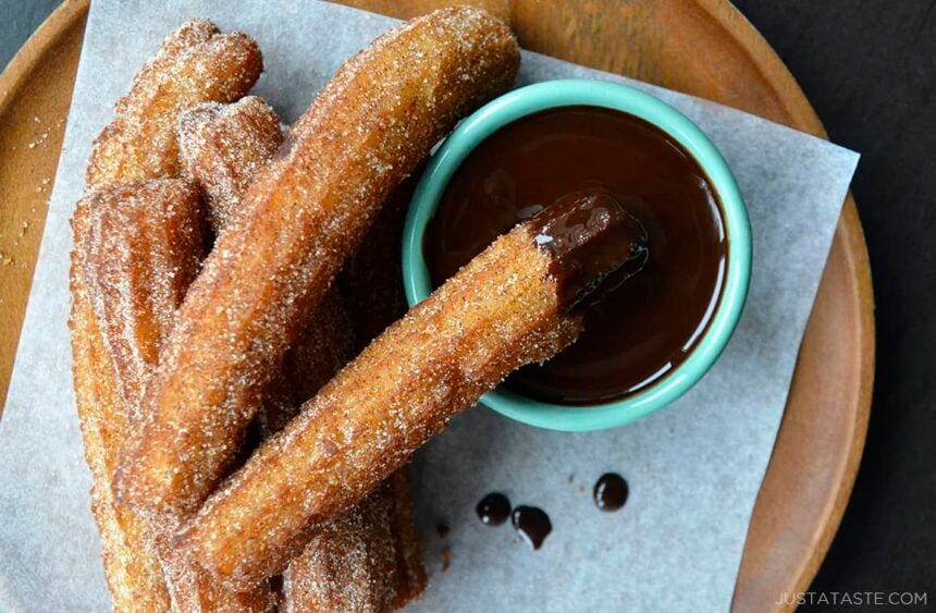 Top down view of easy homemade churros dunked in chocolate sauce