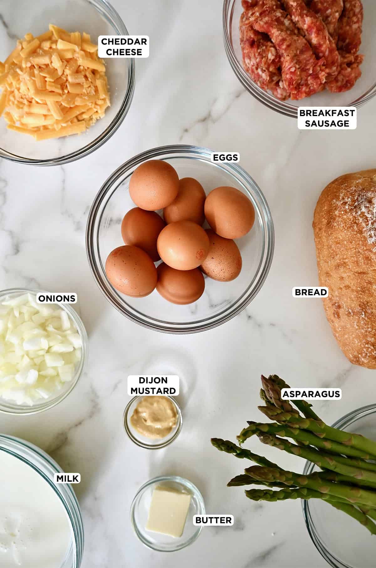 Ingredients to make an overnight breakfast casserole with sausage and asparagus.