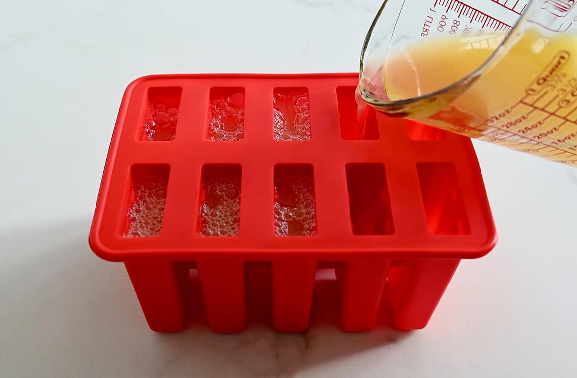 Cocktail mixture being poured into a silicone mold