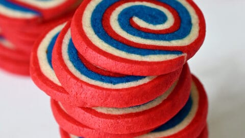 A tall stack of red, white and blue pinwheel cookies.