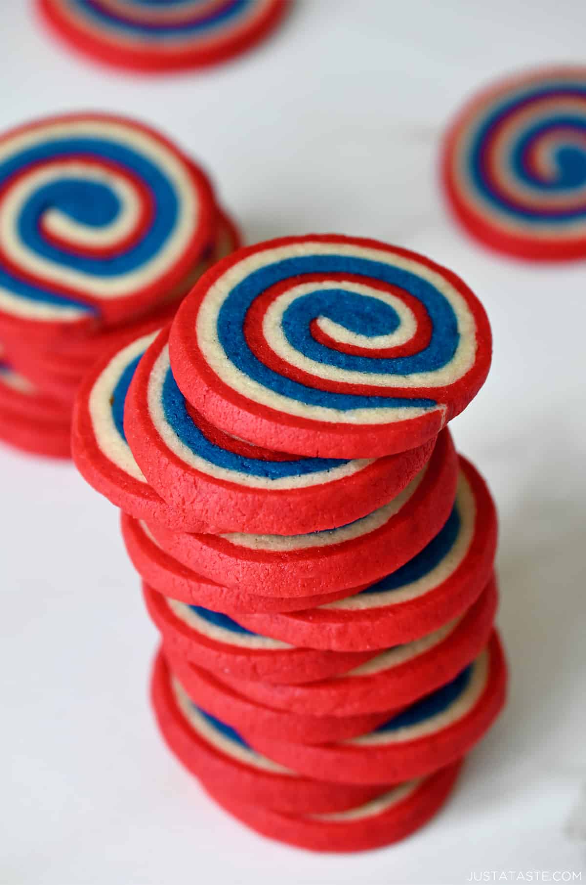 A tall stack of red, white and blue pinwheel cookies.