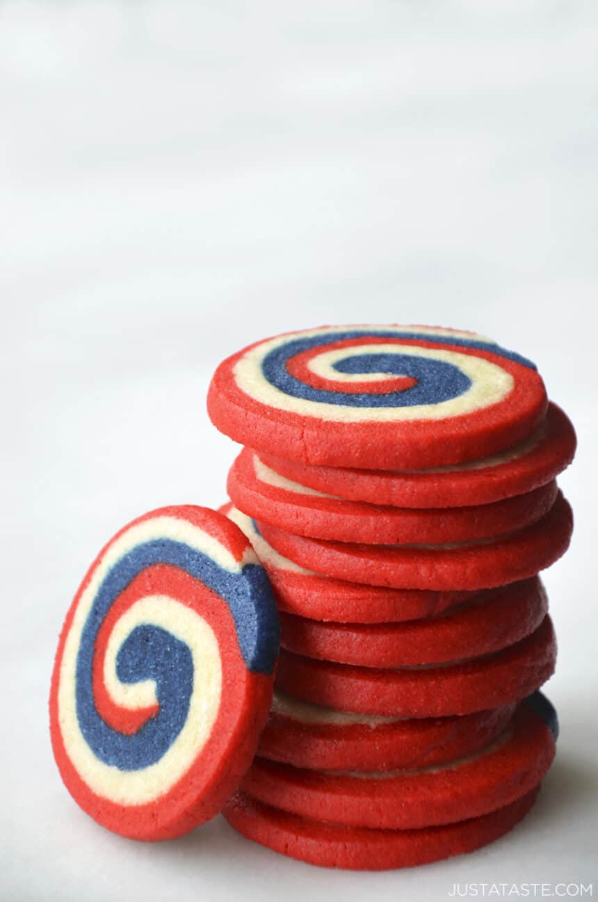 A tall stack of red, white and blue pinwheel icebox cookies