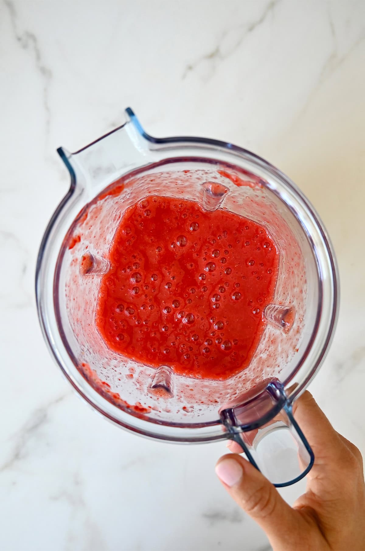 Strawberry purée in a blender.