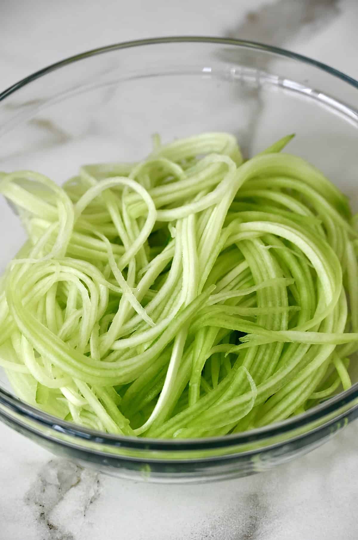 Cucumber matchsticks in a glass bowl.