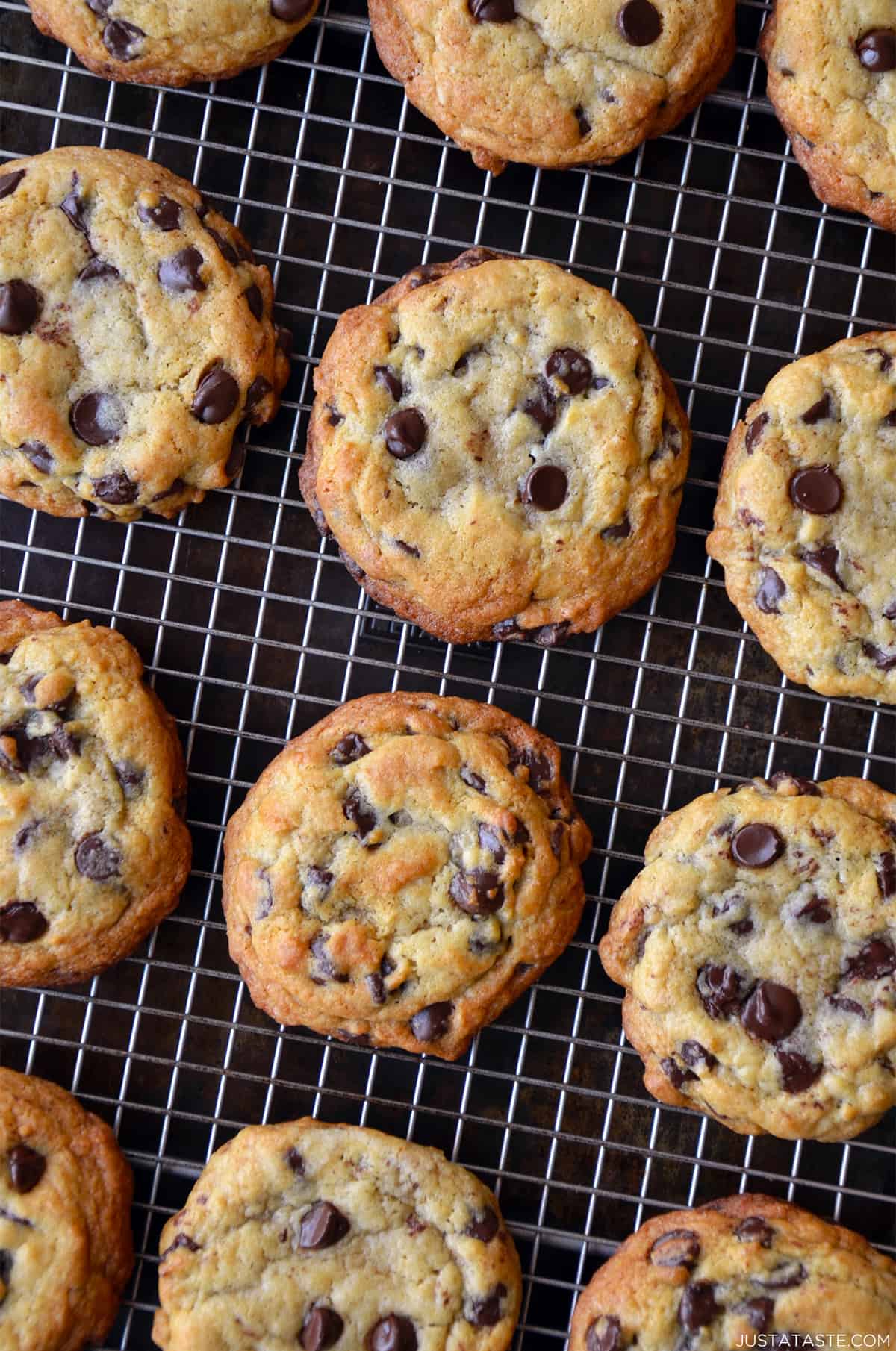 Golden brown chocolate chip cookies cooling on a wire rack.