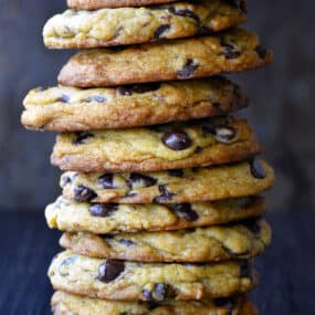 A tall stack of Secret Ingredient Chocolate Chip Cookies made with cream cheese.