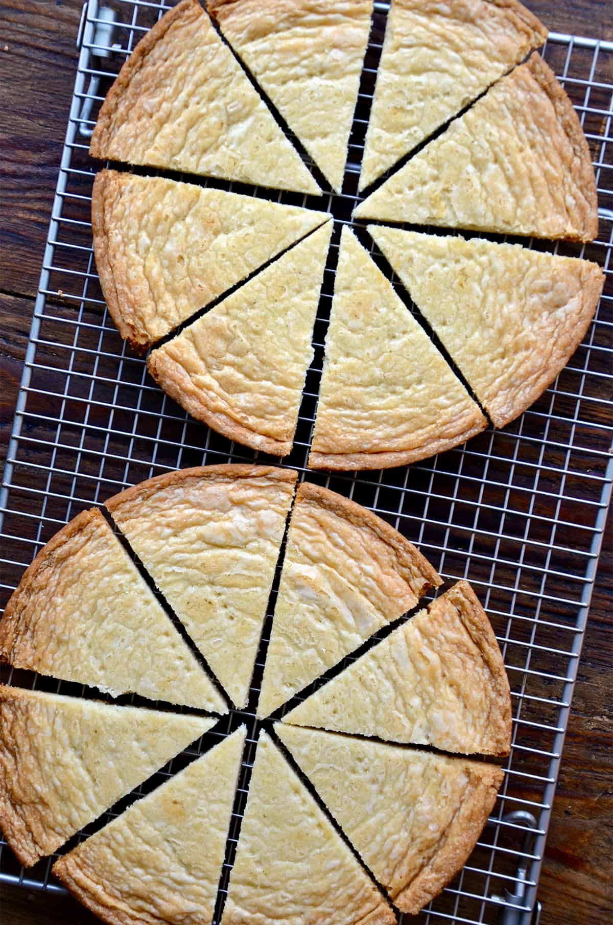 Baked shortbread, cut into wedges, cools on a baking rack.