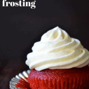 A single red velvet cupcake with swirled cream cheese frosting.