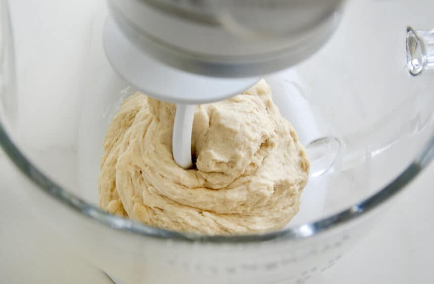 A stand mixer bowl containing dough