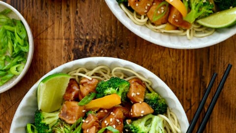 A top-down view of two bowls containing 30-Minute Chicken and Broccoli Stir-Fry and chopsticks