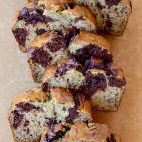 Chocolate Swirl Banana Bread sliced on a wooden cutting board