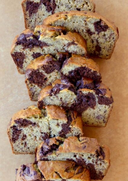 Chocolate Swirl Banana Bread sliced on a wooden cutting board