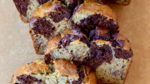 Chocolate Swirl Banana Bread sliced on a wooden cutting board