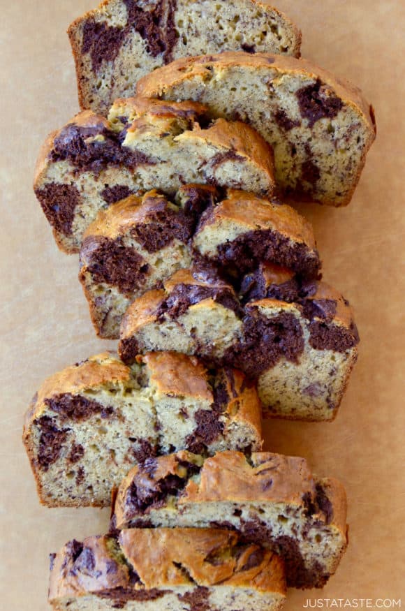 Chocolate Swirl Banana Bread sliced on a wooden cutting board