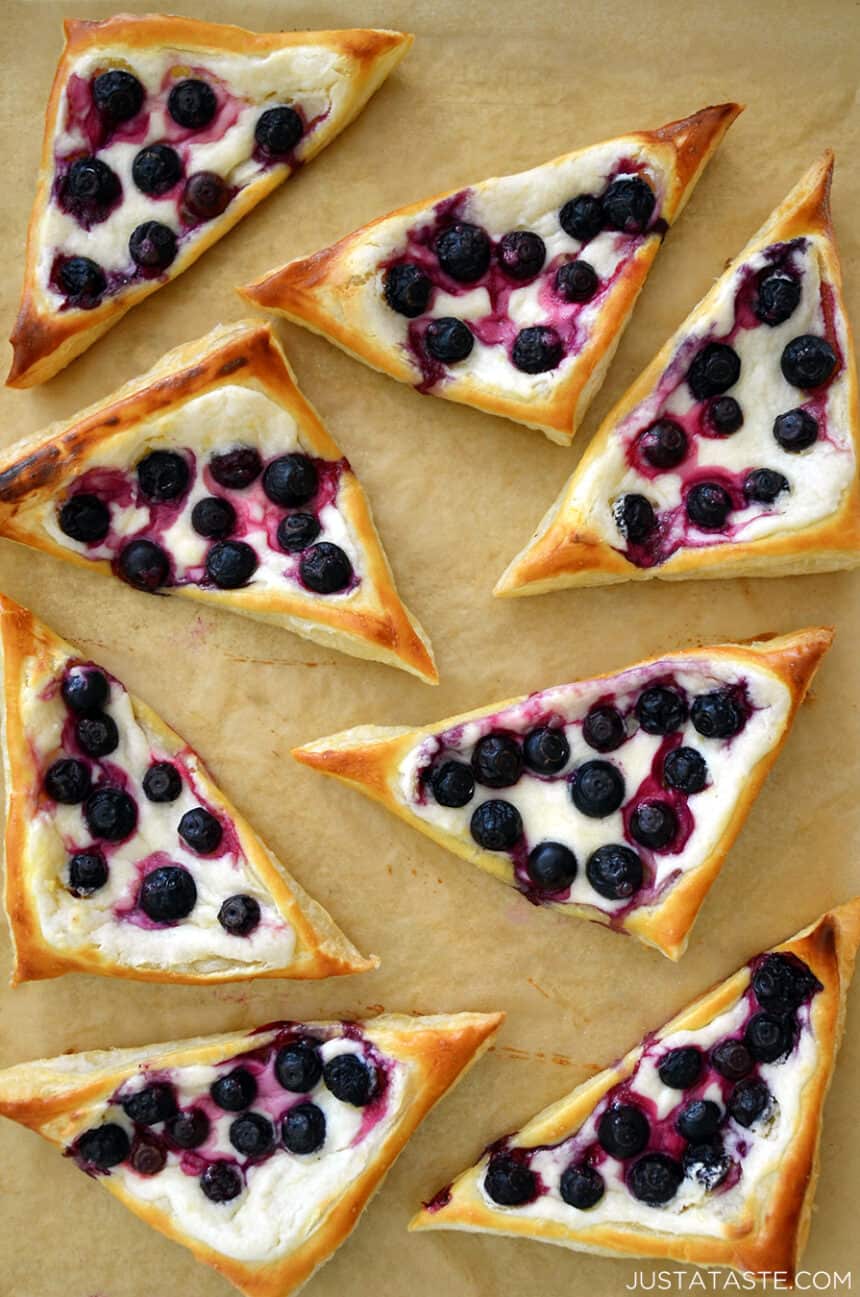 Top-down view of Blueberry Cream Cheese Pastries on brown parchment paper.