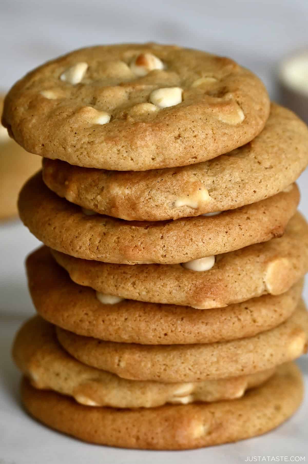 White chocolate cheesecake cookies stacked eight high.