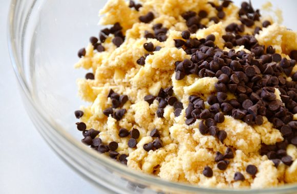 Clear bowl with chocolate chips and shortbread mixture