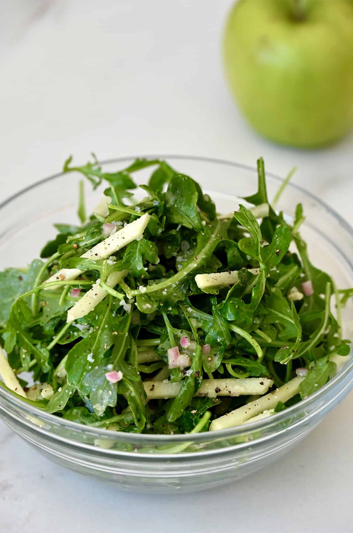 Arugula salad with slices of green apple all tossed in a Dijon mustard vinaigrette. 