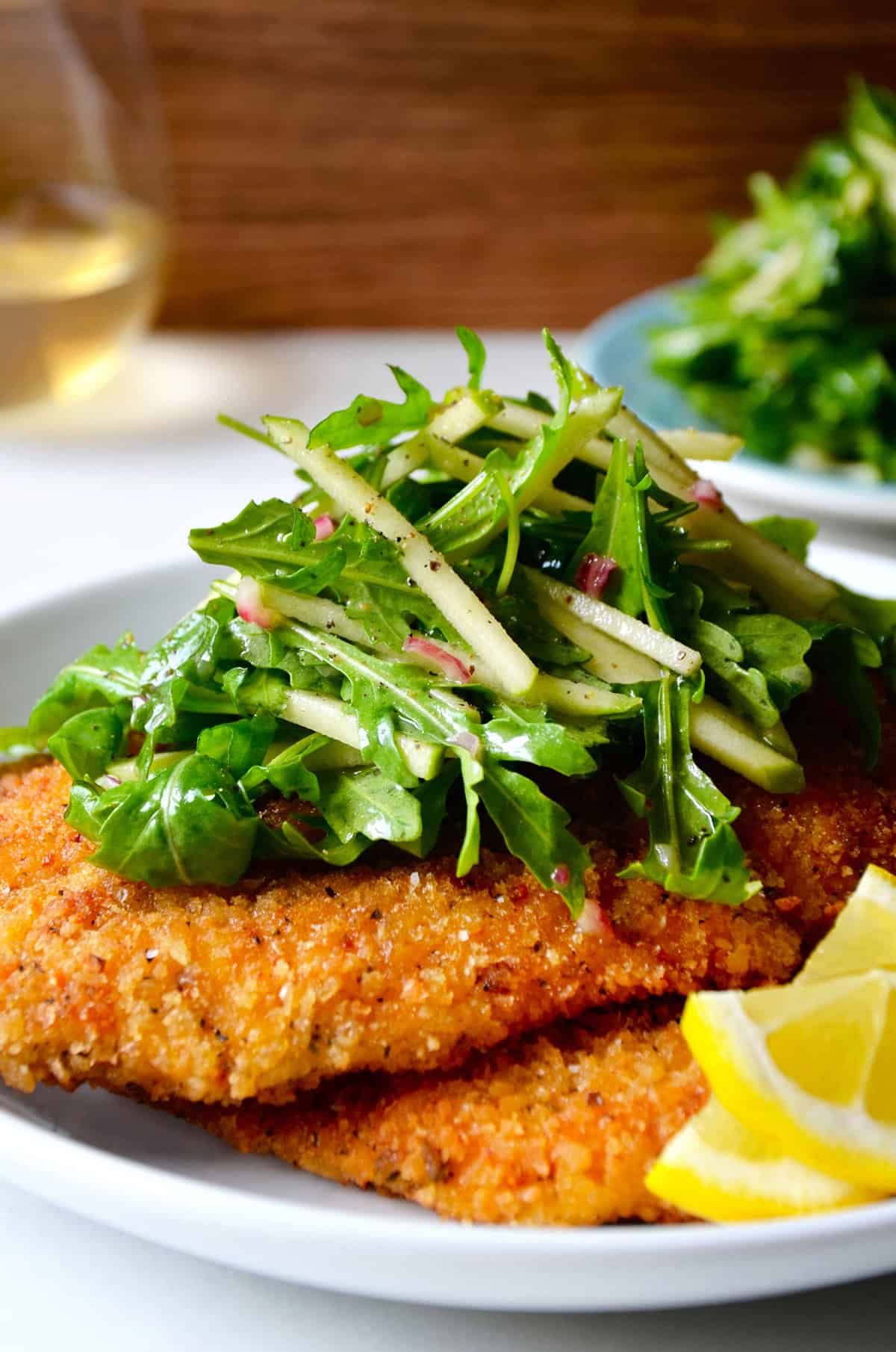 Italian chicken Milanese topped with dressed arugula.