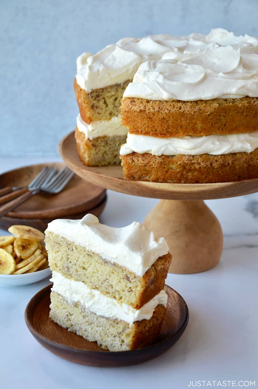 A slice of banana cake with cream cheese frosting on a plate