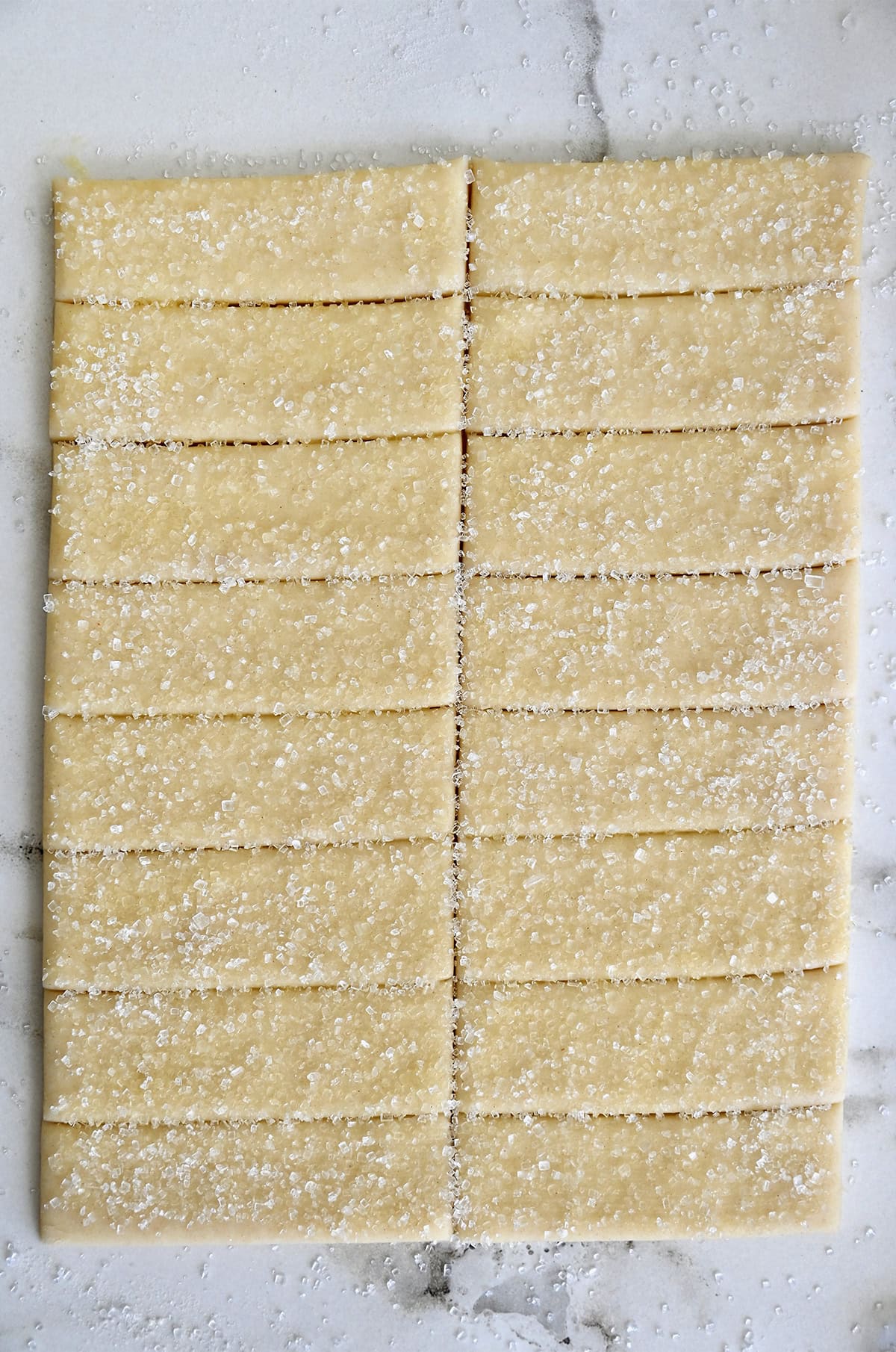 Pie dough cut into perfect strips, brushed with egg wash and sprinkled with sanding sugar.