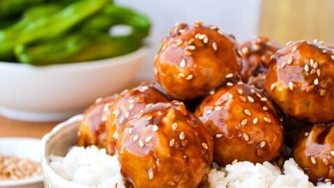 Baked Teriyaki Chicken Meatballs over white rice in large bowl