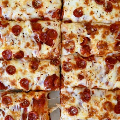 Cheese and pepperoni focaccia pizza cut into slices.