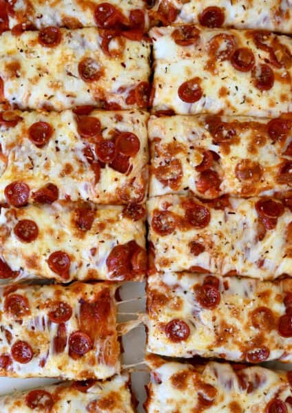 Cheese and pepperoni focaccia pizza cut into slices.
