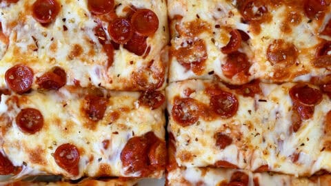 Cheese and pepperoni focaccia pizza cut into slices.