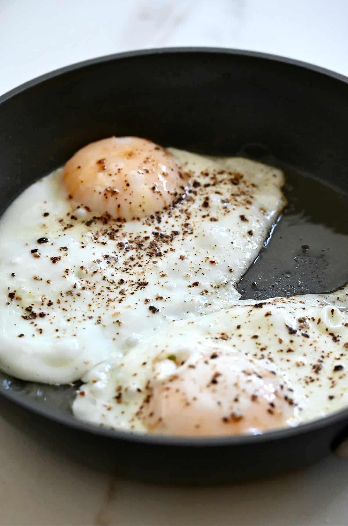 Two over-easy eggs in a skillet.