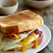 The ultimate breakfast sandwich with two fried eggs, crispy bacon, cheddar cheese and strawberry jam.