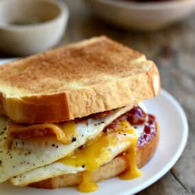 The ultimate breakfast sandwich with two fried eggs, crispy bacon, cheddar cheese and strawberry jam.