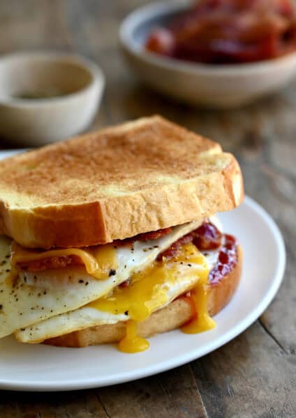 The ultimate breakfast sandwich with two fried eggs, crispy bacon, cheddar cheese and strawberry jam.