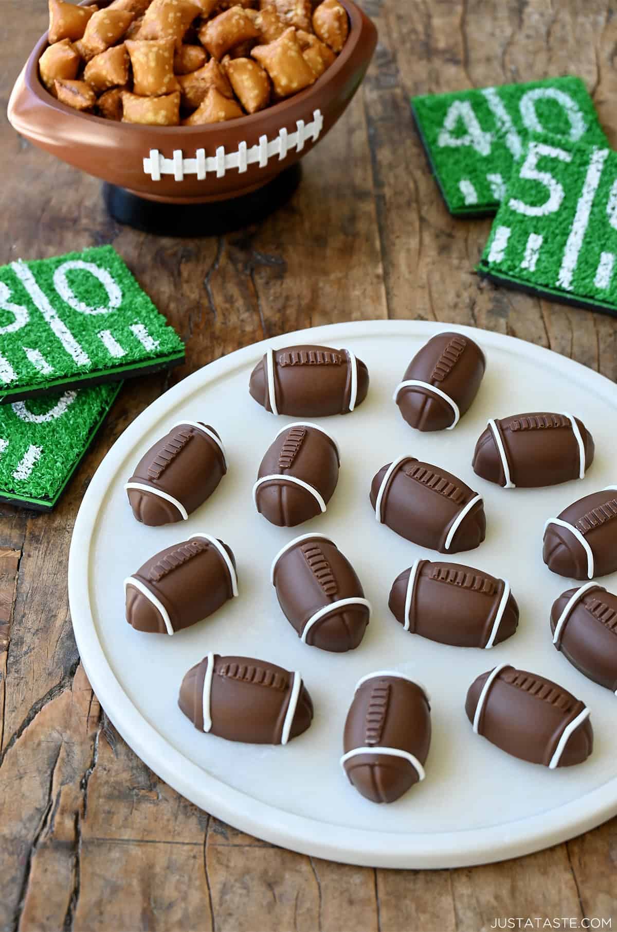 Chocolate-Covered Pretzel Footballs on a marble serving platter.