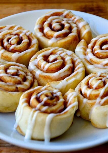 Pizza Dough Cinnamon Rolls with glaze on serving plate