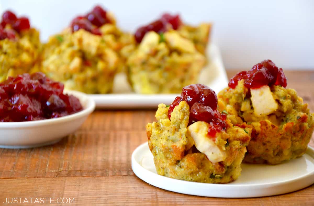 Leftover turkey and stuffing muffins topped with cranberry sauce on a white plate.