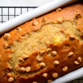 Loaf of peanut butter banana bread studded with peanut butter chips