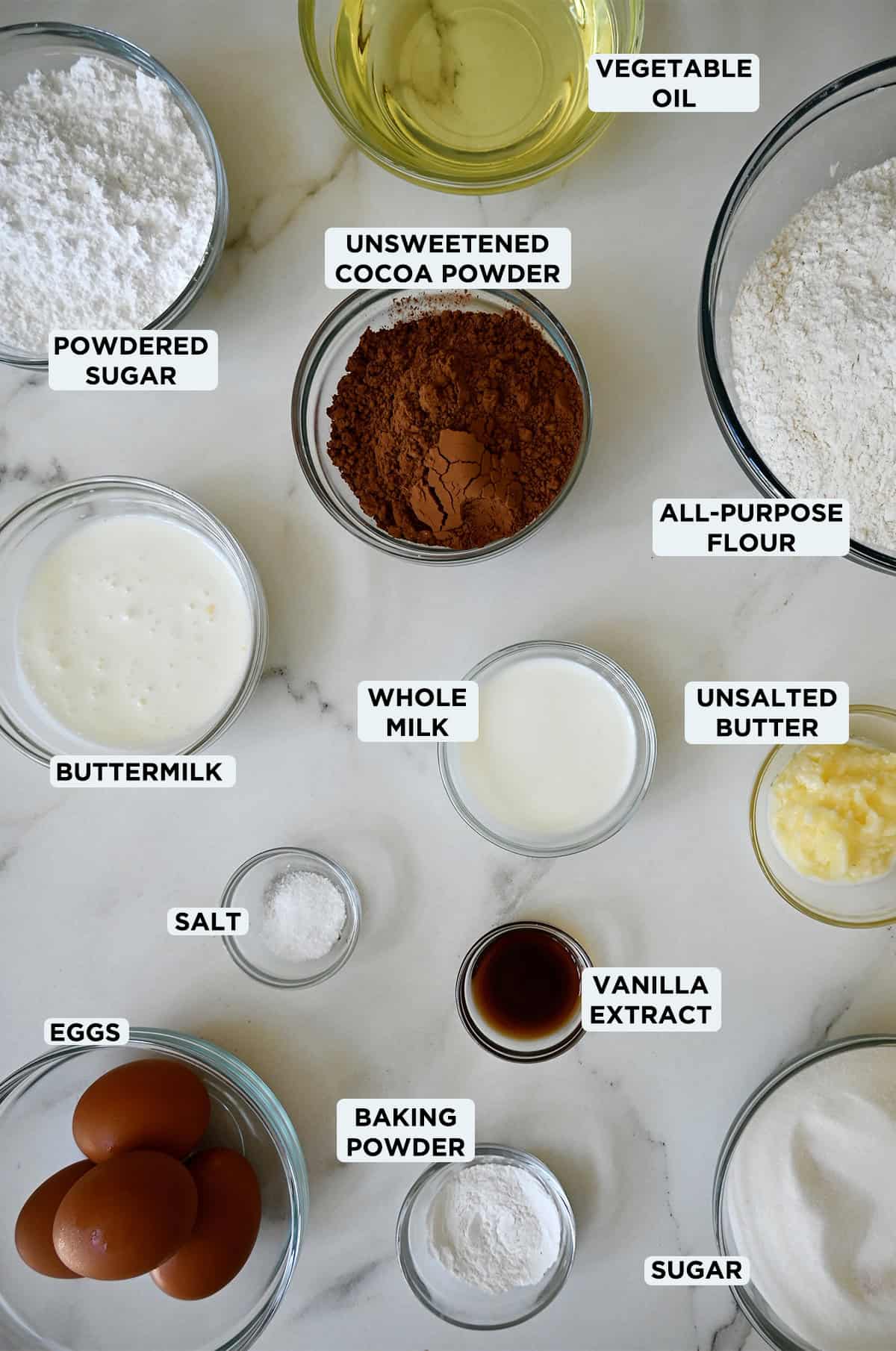 Chocolate doughnut ingredients in various sizes of glass bowls.