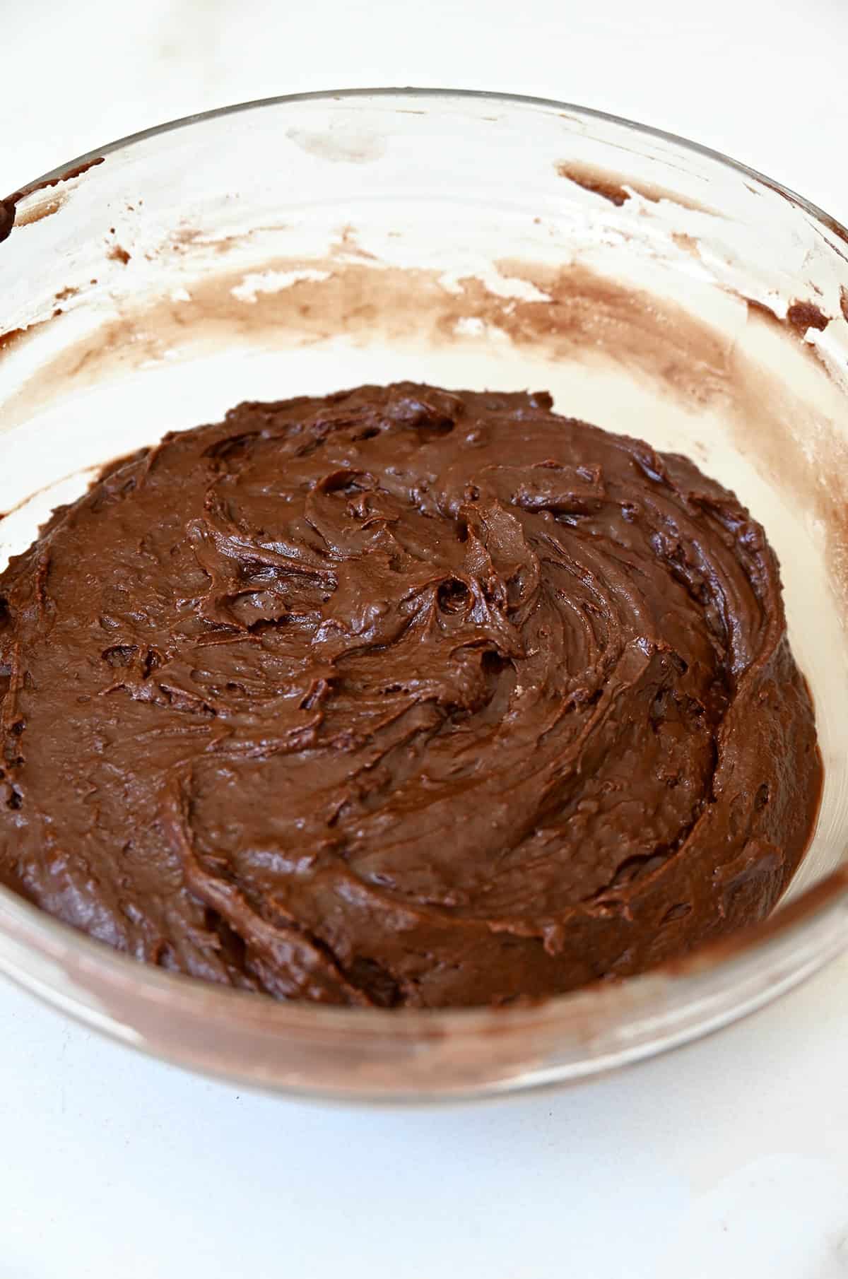 Chocolate doughnut batter in a large bowl.