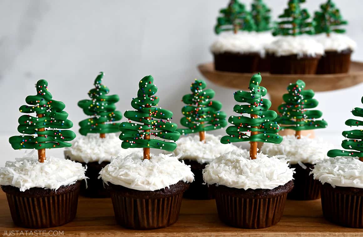 A "forest" of Chocolate Christmas Tree Cupcakes with Cream Cheese Frosting and pretzel/candy melt toppers